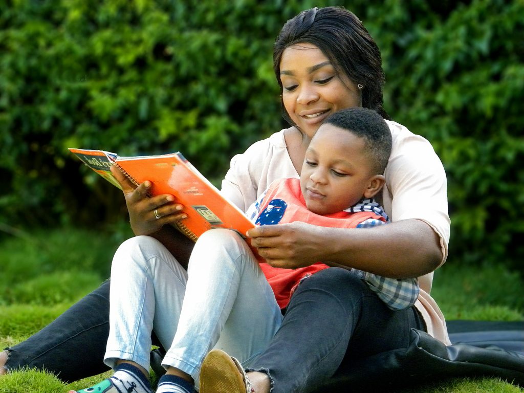 parent reading book to child.